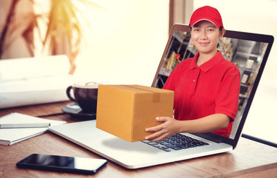 Portrait of young man using mobile phone in box