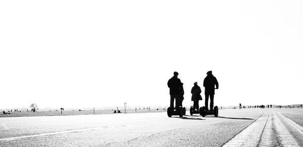 People on road against clear sky