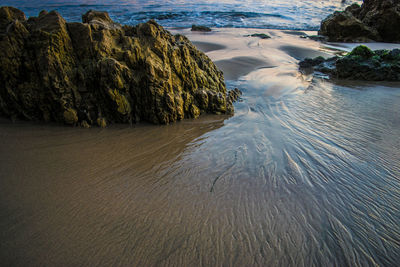 High angle view of rock on wet shore