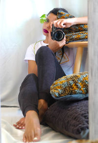 Woman photographing at home