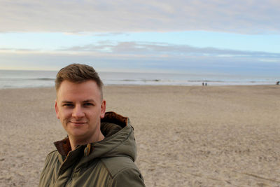 Portrait of man standing at beach