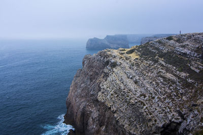 Scenic view  of sea cliffs against sky