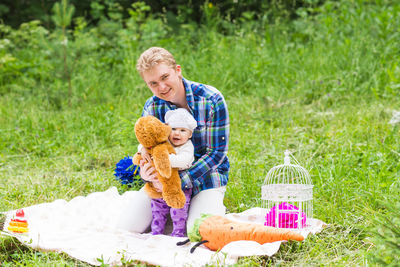 Full length of a happy young man with toy basket