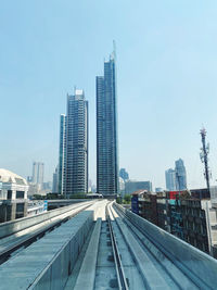 Modern buildings in city against clear sky