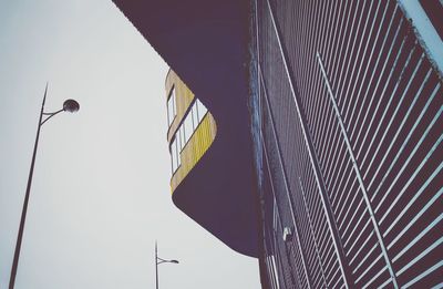 Low angle view of street light against building