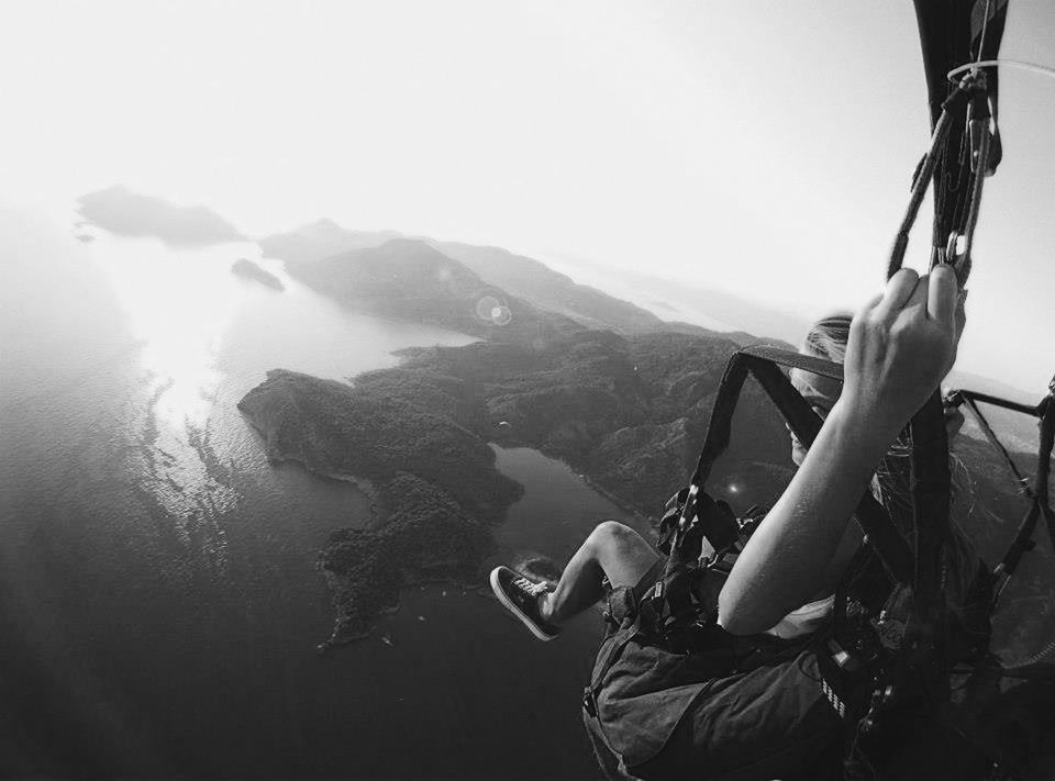 lifestyles, mountain, leisure activity, men, person, mountain range, rear view, scenics, clear sky, holding, tranquil scene, water, nature, tranquility, beauty in nature, vacations, sitting, sunlight