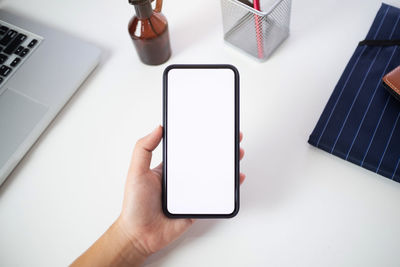 High angle view of person using smart phone on table