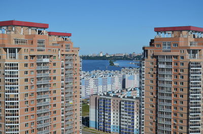 Buildings in city against clear sky