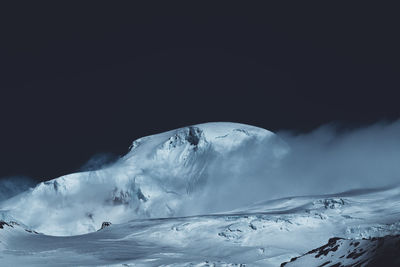 Scenic view of snowcapped mountains against sky during winter