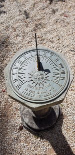 High angle view of clock on manhole