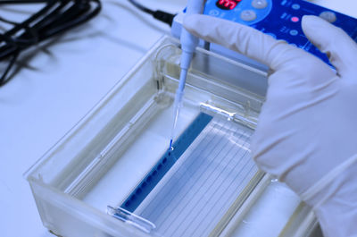 Close-up of hand testing chemical in lab