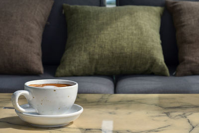 Close-up of coffee cup on table