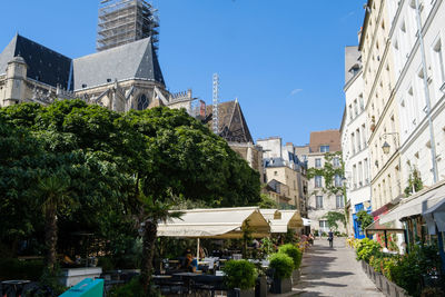 Street amidst buildings against sky in city