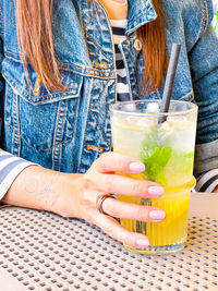 Midsection of a woman drinking glass