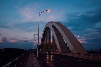 Bridge against cloudy sky at dusk