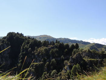 Scenic view of mountains against clear blue sky