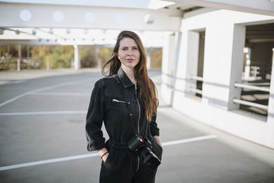 Portrait of a young woman standing outdoors