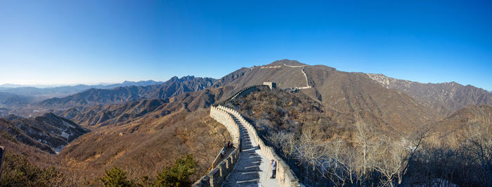 Panoramic view of mountain range against blue sky