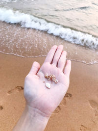 High angle view of hand on beach
