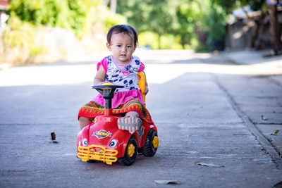 Portrait of cute girl toy car