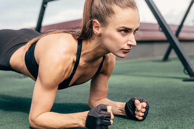 Woman exercising on floor in gym