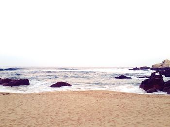 Scenic view of beach against clear sky