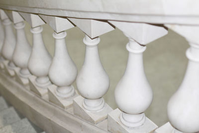 Close-up of chess pieces on railing