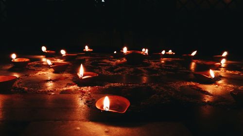 Close-up of illuminated tea light candles at night