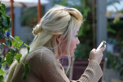 Young woman using smart phone outdoors