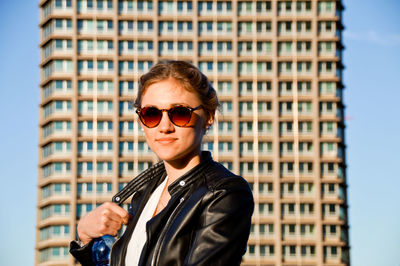 Portrait of smiling young woman in city