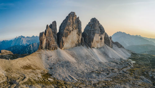 Panoramic view of rocky mountains against sky during sunset