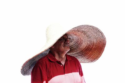 Smiling man wearing large hat against white background