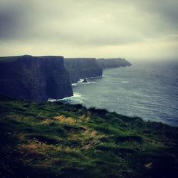 Scenic view of sea against cloudy sky