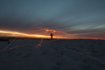 Scenic view of beach against sky at night