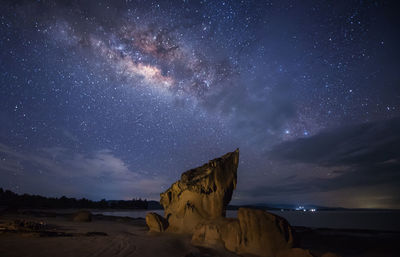 Scenic view of landscape against sky at night