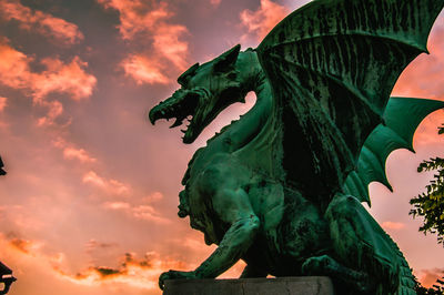 Low angle view of statue against sky during sunset