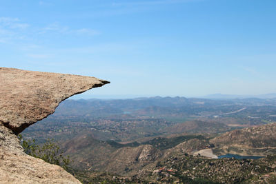 Potato chip rock - flat overhanging rock in front of a landscape