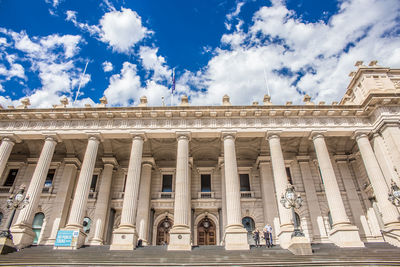 Low angle view of building against cloudy sky