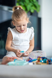 Portrait of cute girl playing with teddy bear