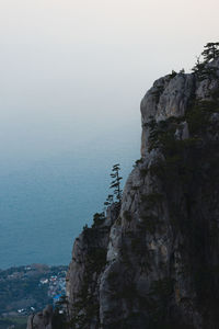 Rock formations by sea against sky