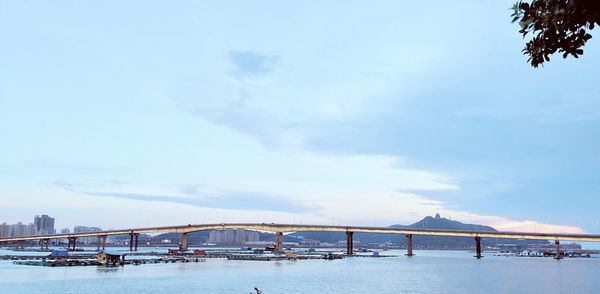 View of boats in sea against cloudy sky