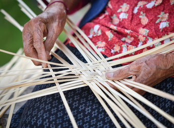 Midsection of woman weaving