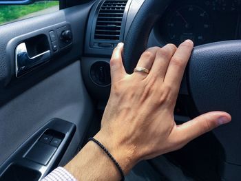 Cropped image of hand on car