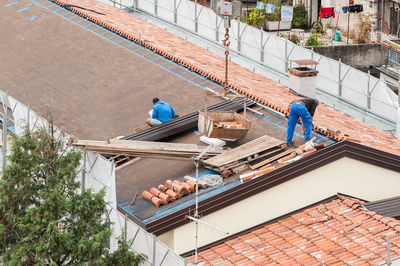 High angle view of people working on roof