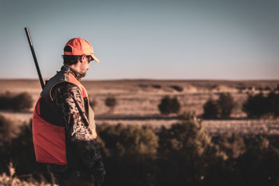 Rear view of man standing on field