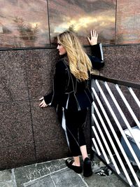 High angle view of woman standing against tiled floor