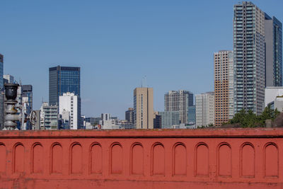 Modern buildings in city against clear sky