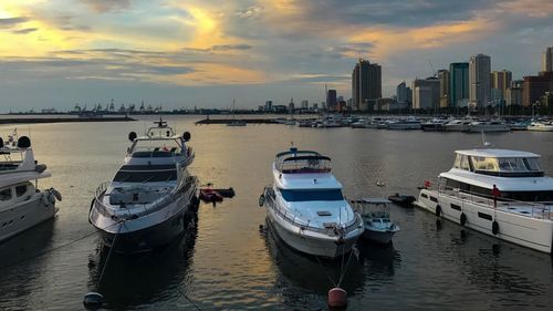 Boats in river with city in background