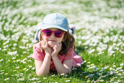 Portrait of girl wearing sunglasses sitting on grass