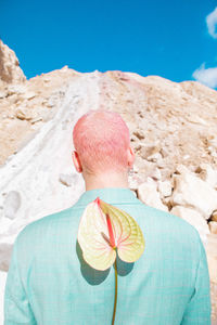 Rear view of woman standing on mountain